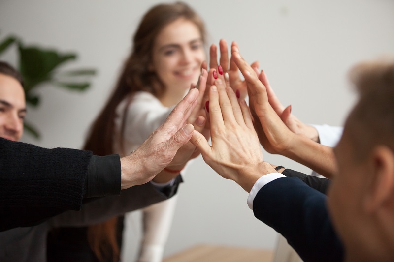 accessibility team shows motivation with group high five